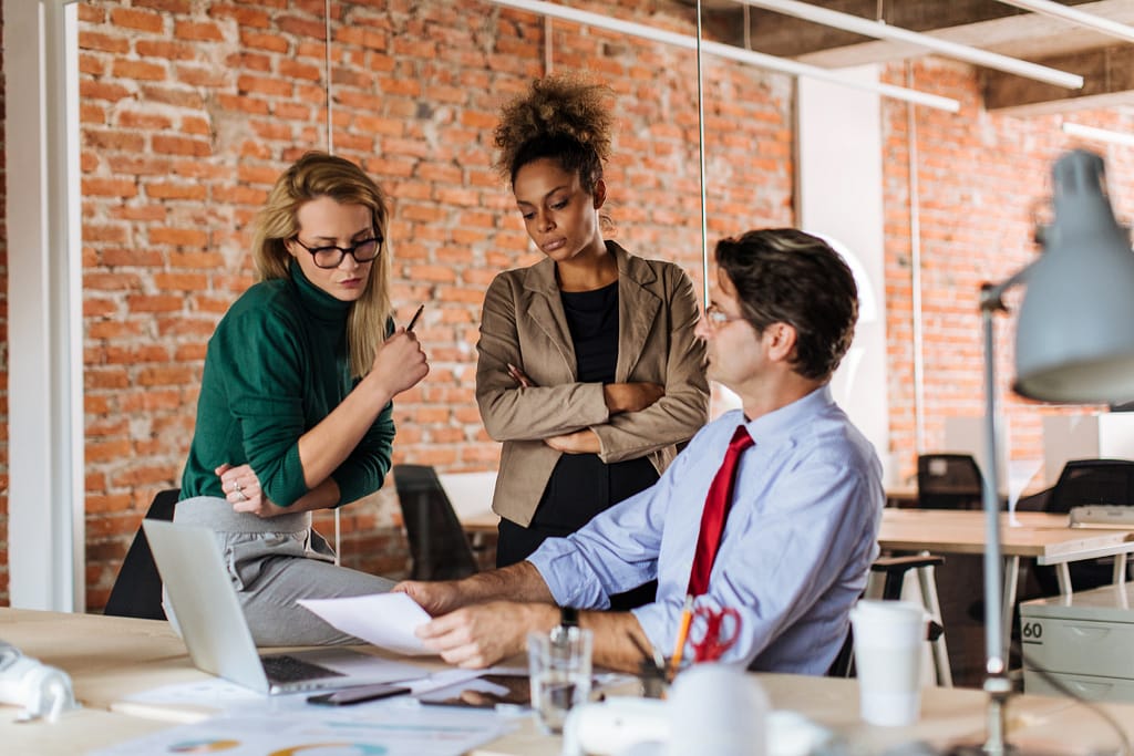 Live Outrageously - Set Healthy Boundaries - Workplace photo of three people in disagreement